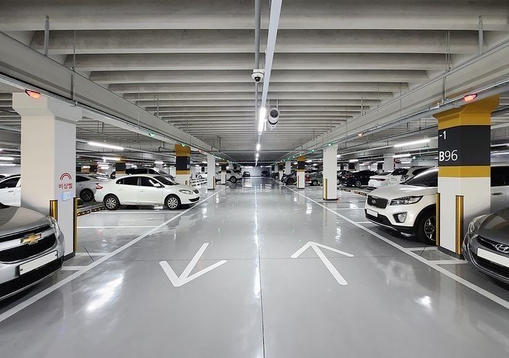 Alternate Side Parking in a basement lot with cars and empty spaces